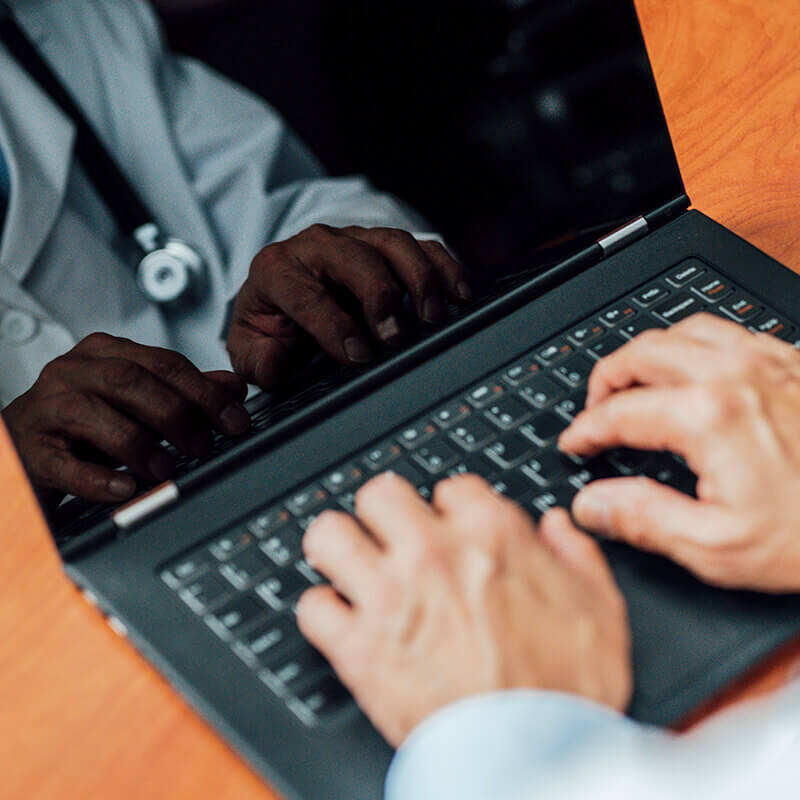 closeup of man typing on laptop