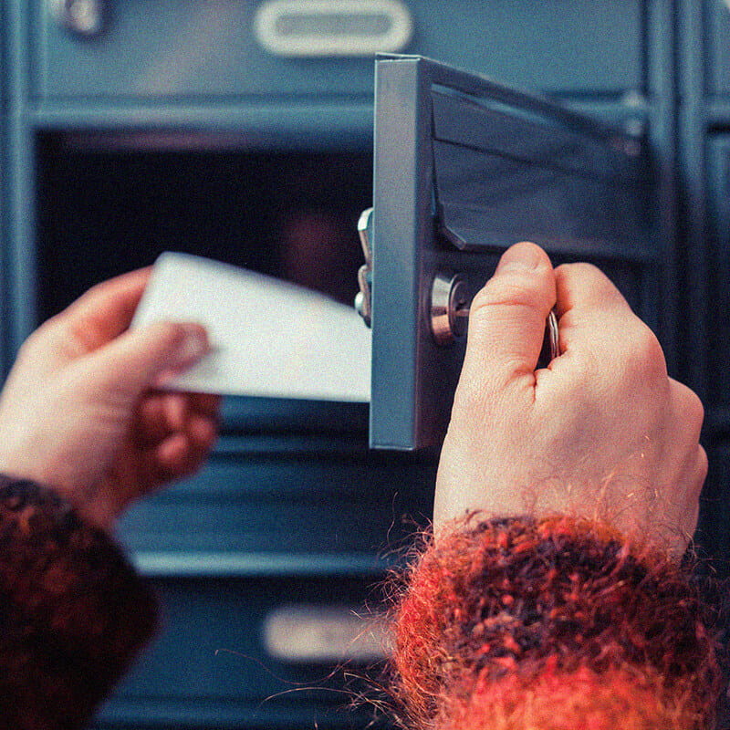 hand pulling mail from mailbox