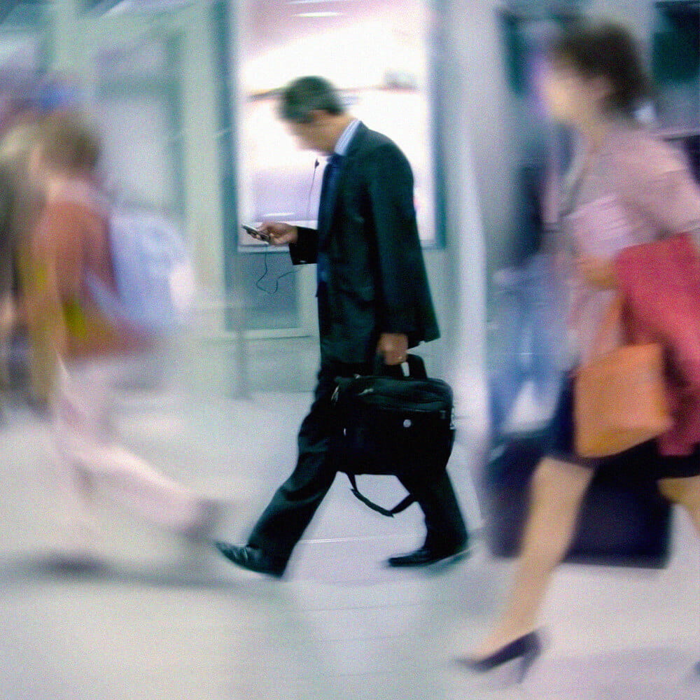 Man with briefcase looking at phone