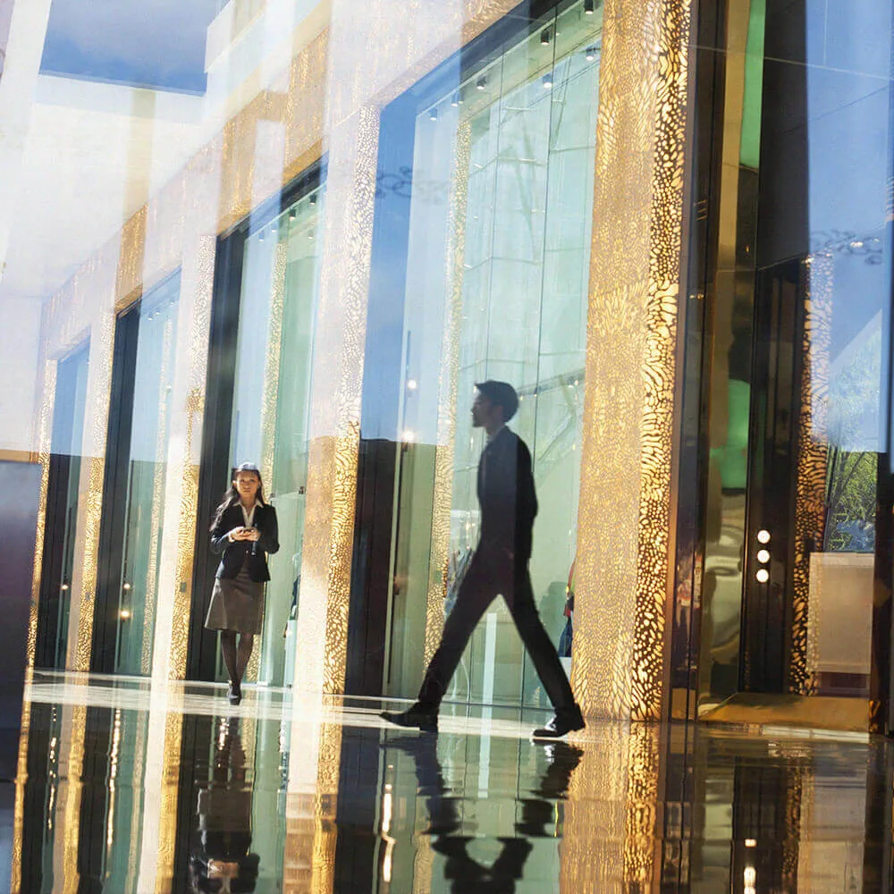 people walking in front of glass building